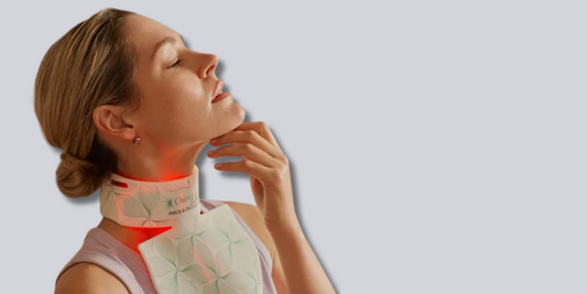 Woman using LED light therapy device on neck and décolletage area, promoting skin rejuvenation and targeted anti-aging care.
